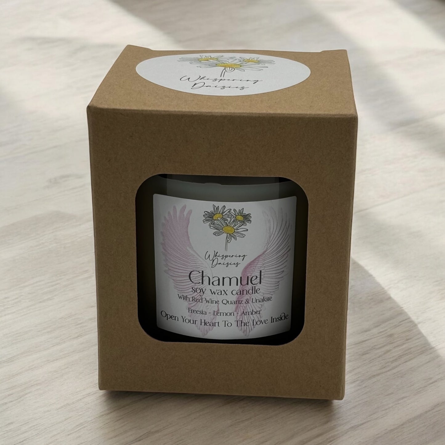 Chamuel Angel Candle in a clear glass jar, topped with red wine quartz and unakite crystals, handmade soy candle from Whispering Daisies in North Devon.