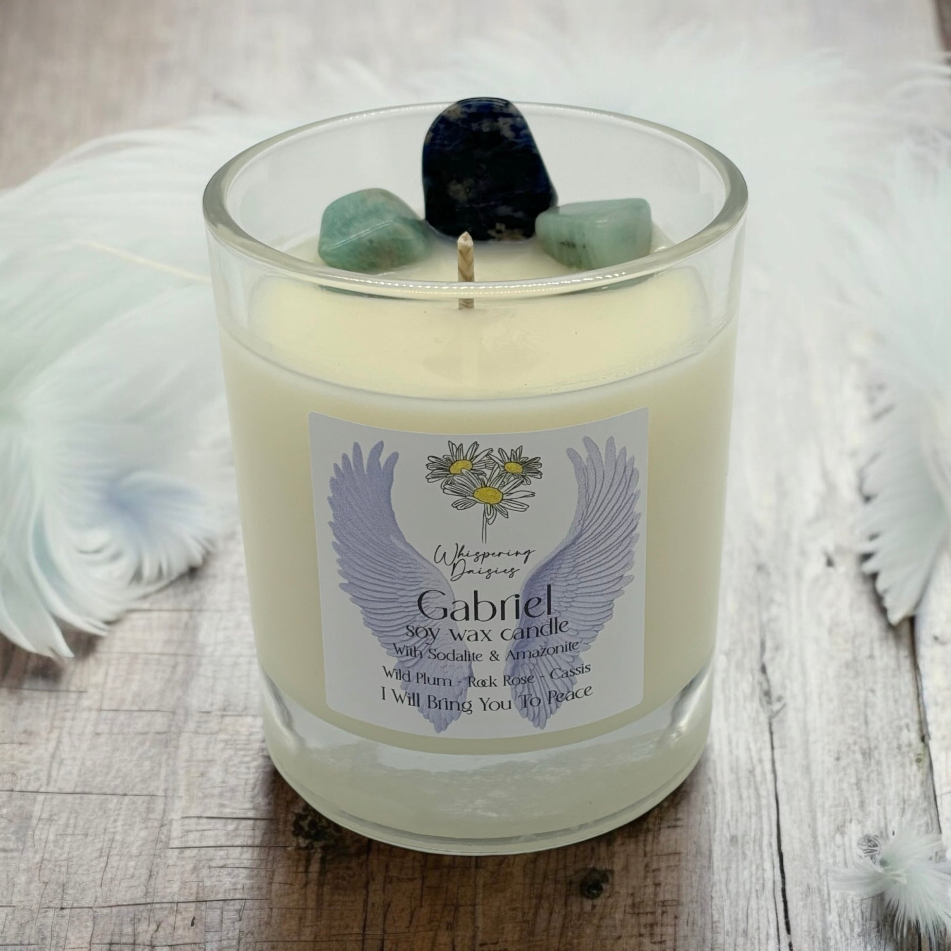Gabriel Angel Candle in a clear glass jar, topped with sodalite and amazonite crystals, handmade soy candle from Whispering Daisies in North Devon.