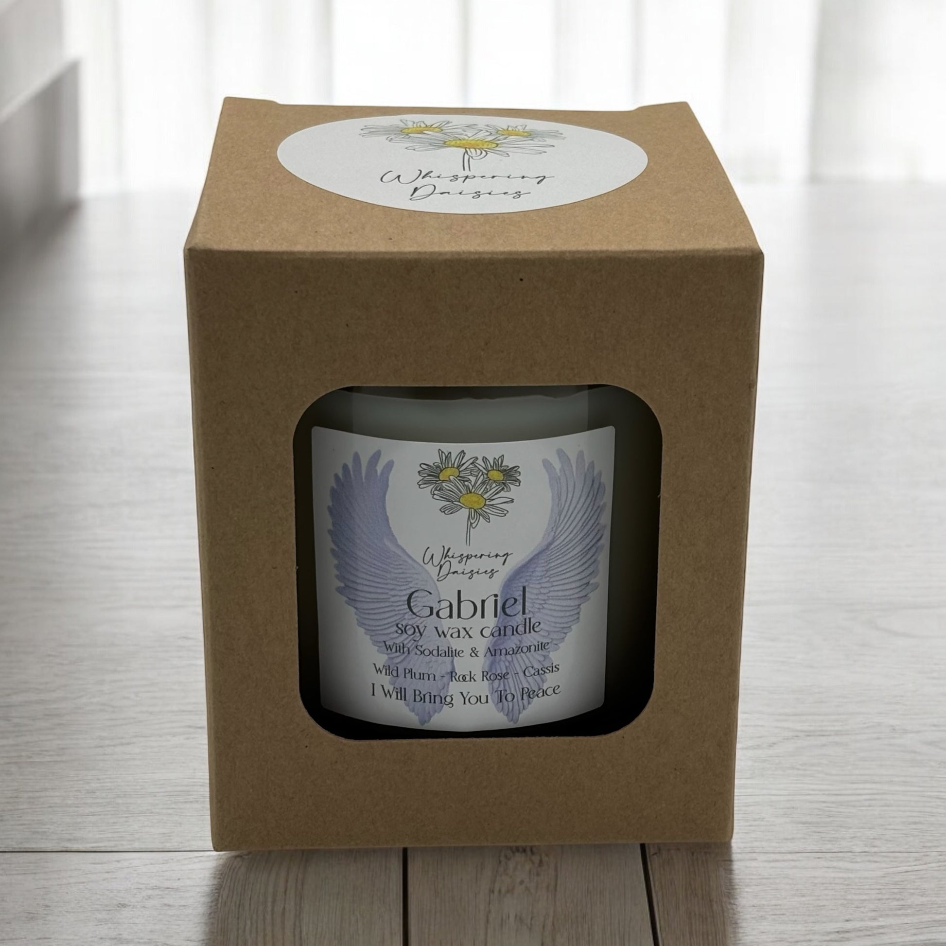 Gabriel Angel Candle in a clear glass jar, topped with sodalite and amazonite crystals, handmade soy candle from Whispering Daisies in North Devon.