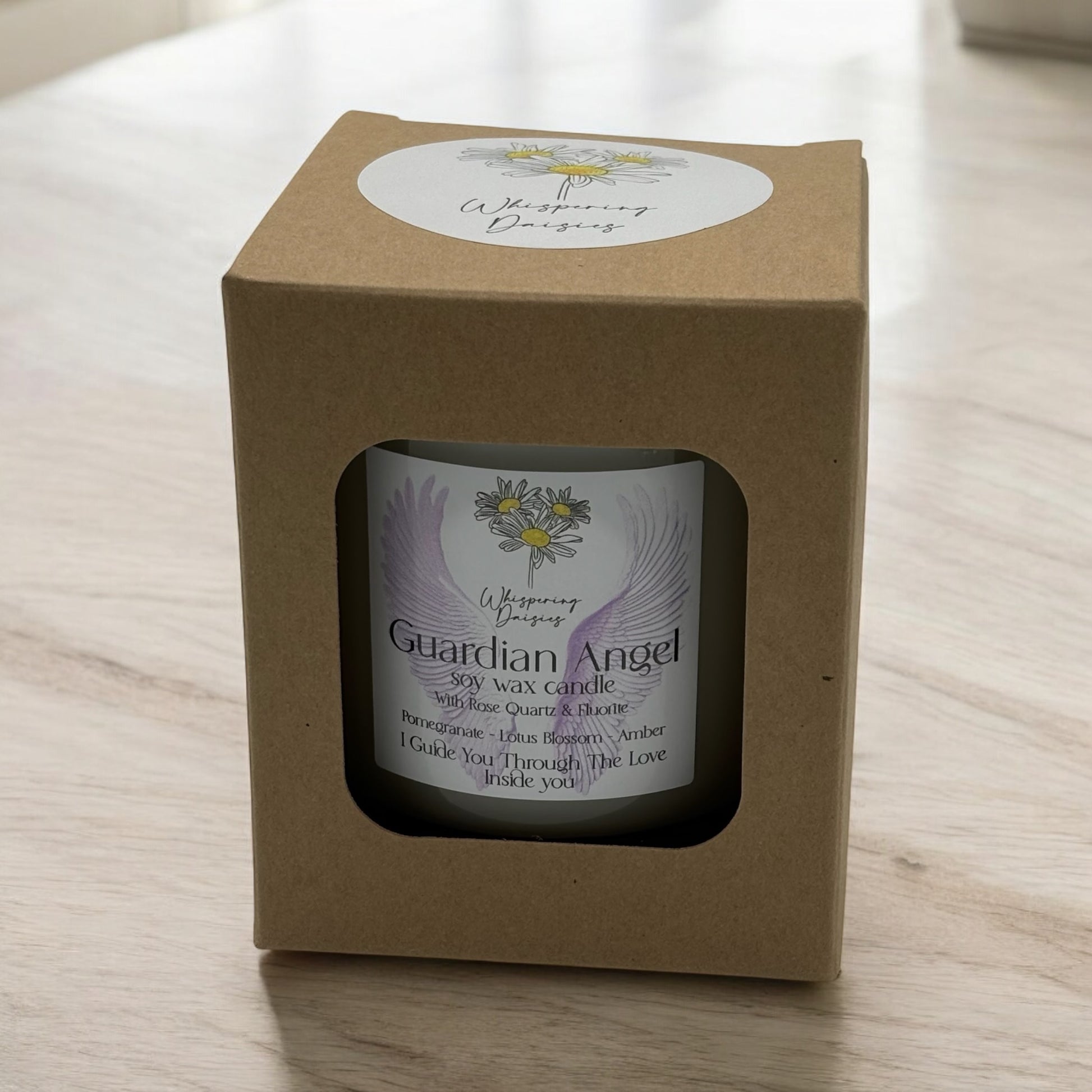 Guardian Angel Candle in a clear glass jar, topped with rose quartz and fluorite crystals, handmade soy candle from Whispering Daisies in North Devon.