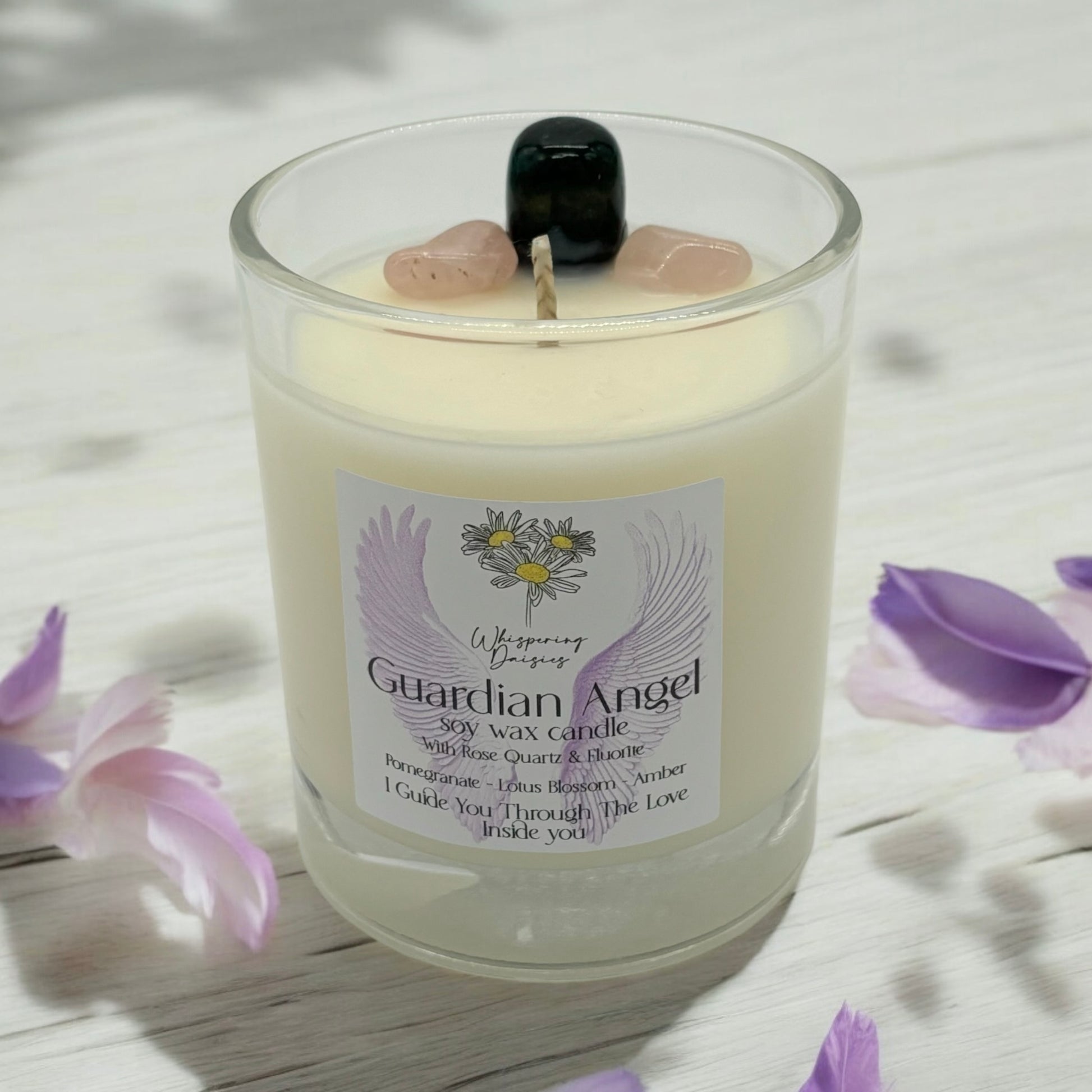 Guardian Angel Candle in a clear glass jar, topped with rose quartz and fluorite crystals, handmade soy candle from Whispering Daisies in North Devon.