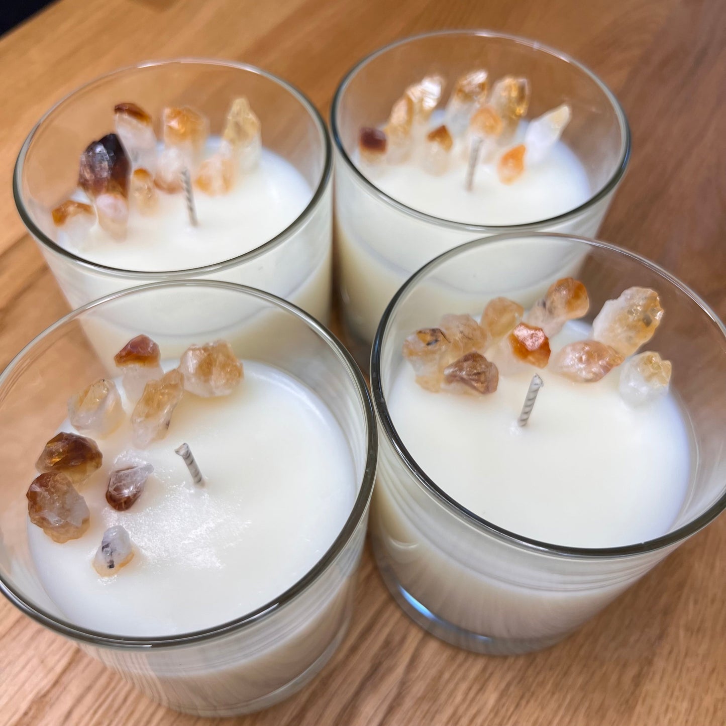 Manifest Magic Candle in a clear glass jar, topped with citrine crystal chips, handmade sherbet lemon soy candle by Whispering Daisies.