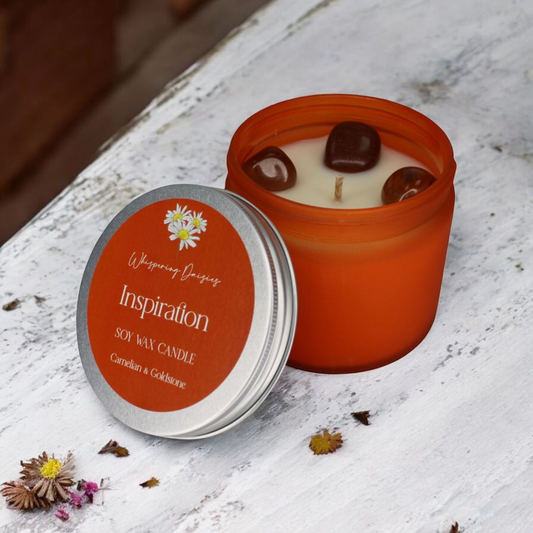 Inspiration Candle with carnelian and goldstone crystals, spicy citrus aroma, handcrafted by Whispering Daisies.