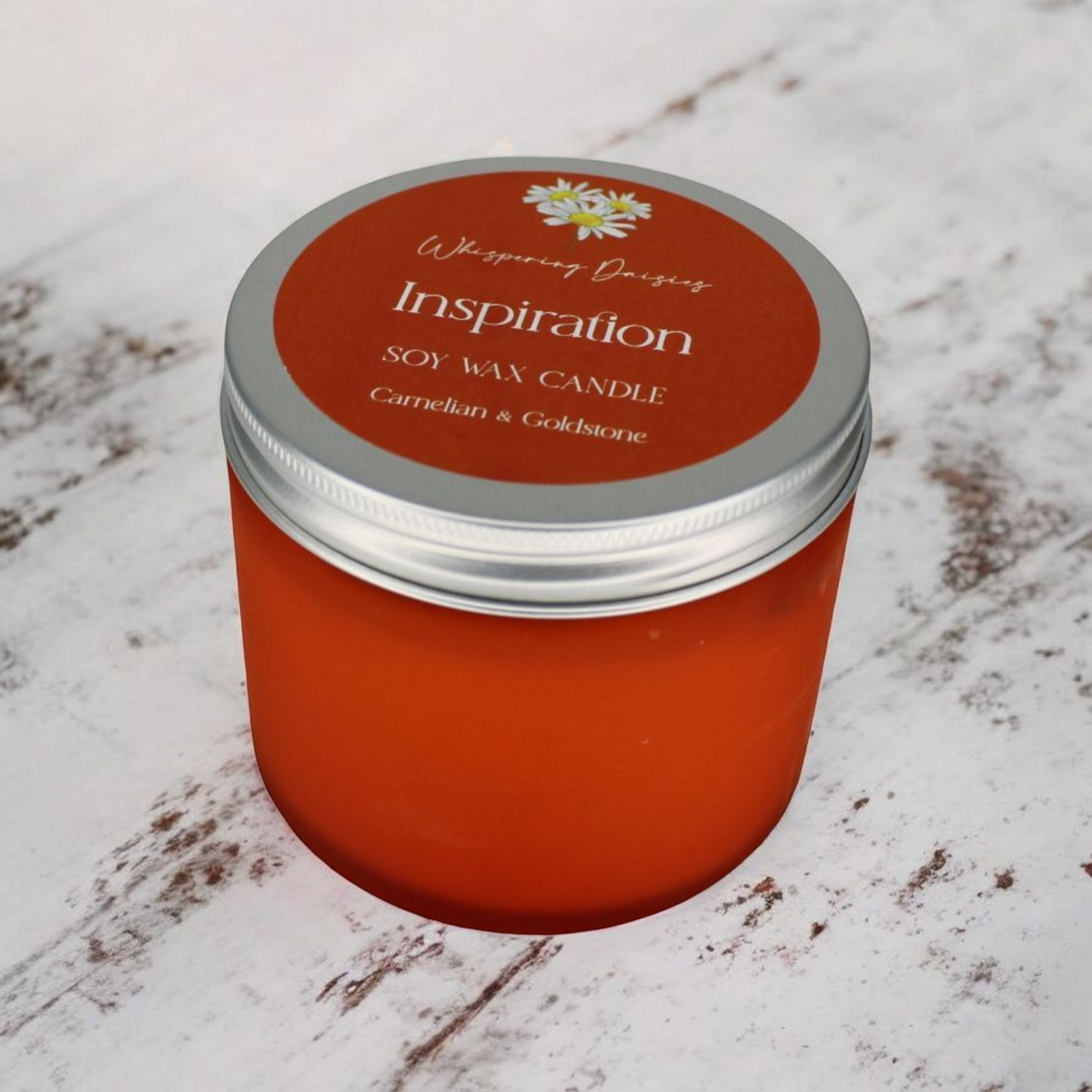 Inspiration Candle with carnelian and goldstone crystals, spicy citrus aroma, handcrafted by Whispering Daisies.