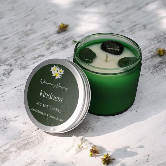 Kindness Candle infused with green quartz and kambala jasper crystals, floral almond scent, handmade in a glass container.