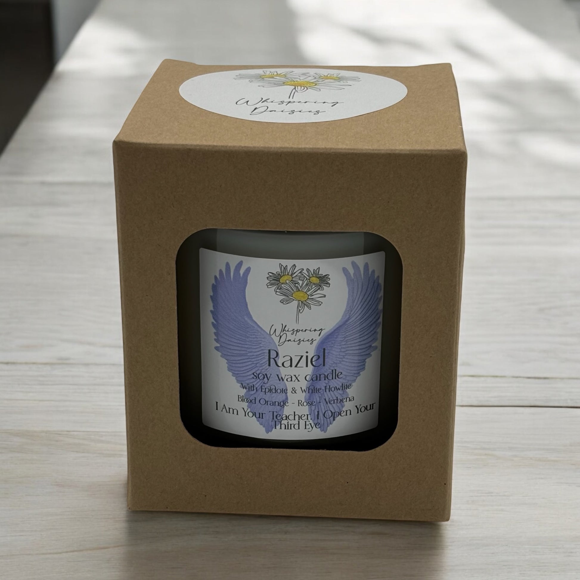 Raziel Angel Candle in a clear glass jar, topped with epidote and white howlite crystals, handmade soy candle from Whispering Daisies in North Devon.