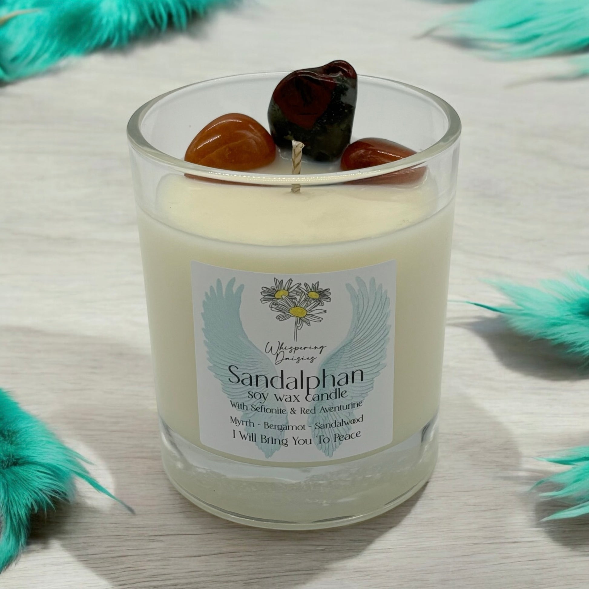 Sandalphon Angel Candle in a clear glass jar, topped with seftonite and red aventurine crystals, handmade soy candle from Whispering Daisies in North Devon.