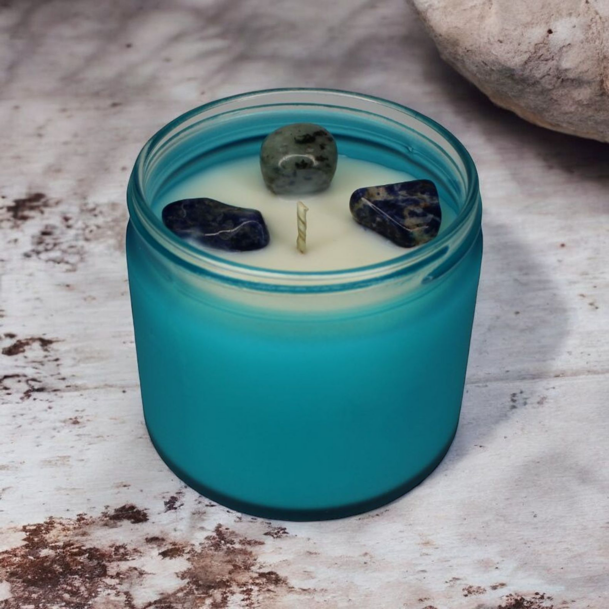 Truth Candle featuring sesame stone and sodalite crystals, aromatic and marine fragrance, handcrafted in North Devon.