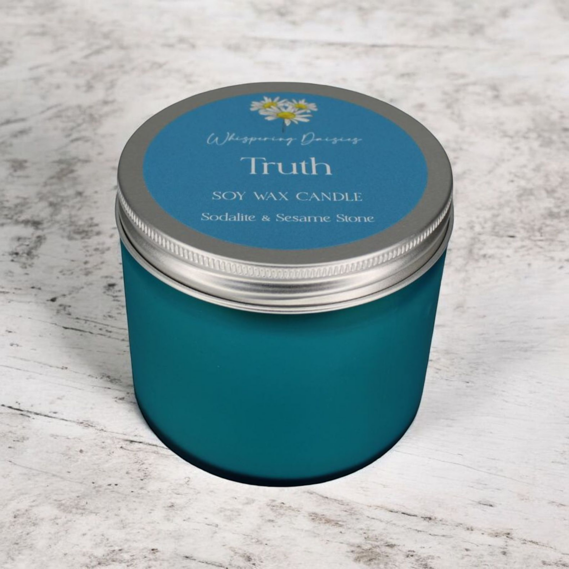 Truth Candle featuring sesame stone and sodalite crystals, aromatic and marine fragrance, handcrafted in North Devon.