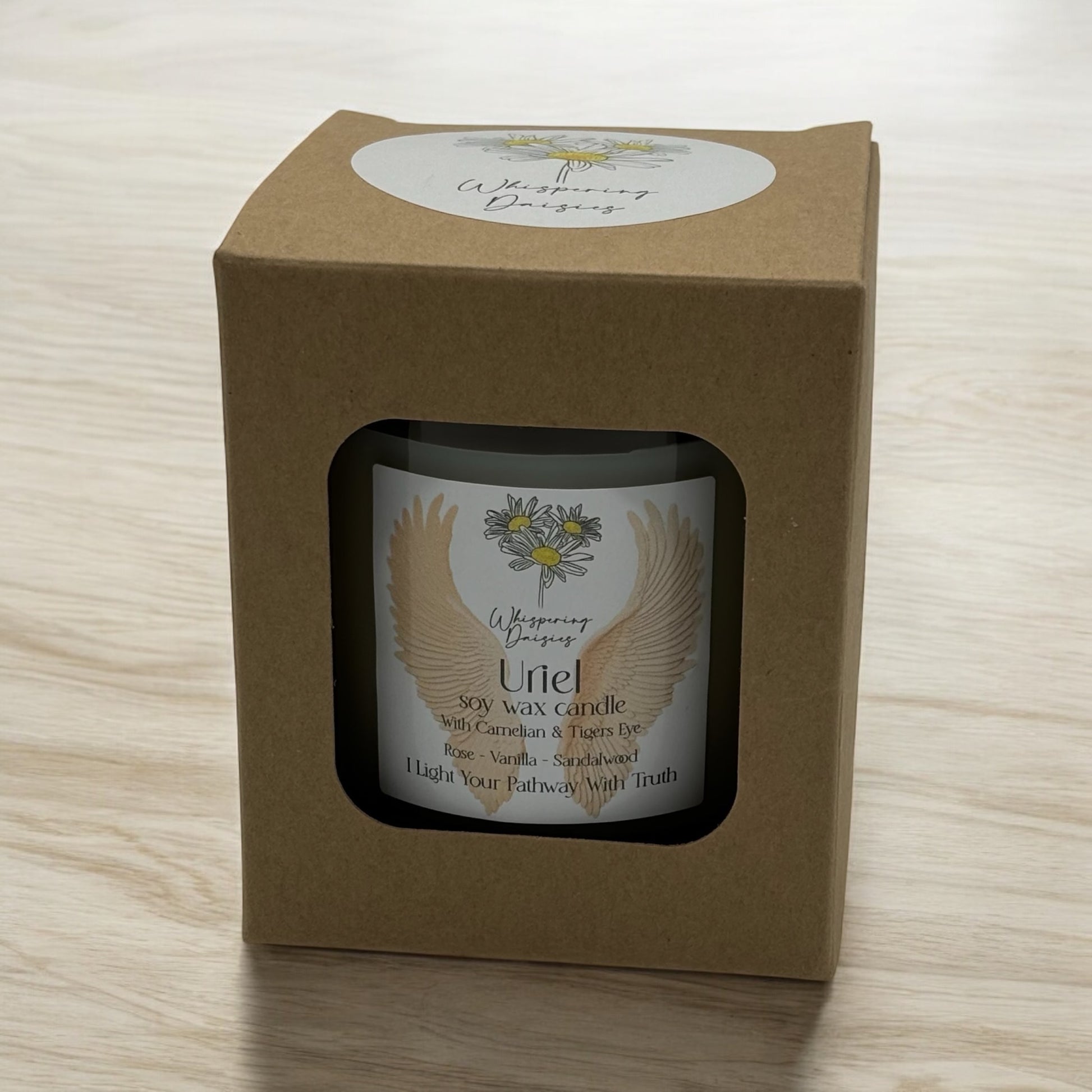 Uriel Angel Candle in a clear glass jar, topped with carnelian and tiger’s eye crystals, handmade soy candle from Whispering Daisies in North Devon.