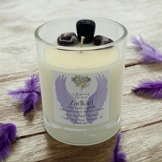 Zadkiel Angel Candle in a clear glass jar, topped with lapis lazuli and amethyst chevron crystals, handmade soy candle from Whispering Daisies in North Devon.