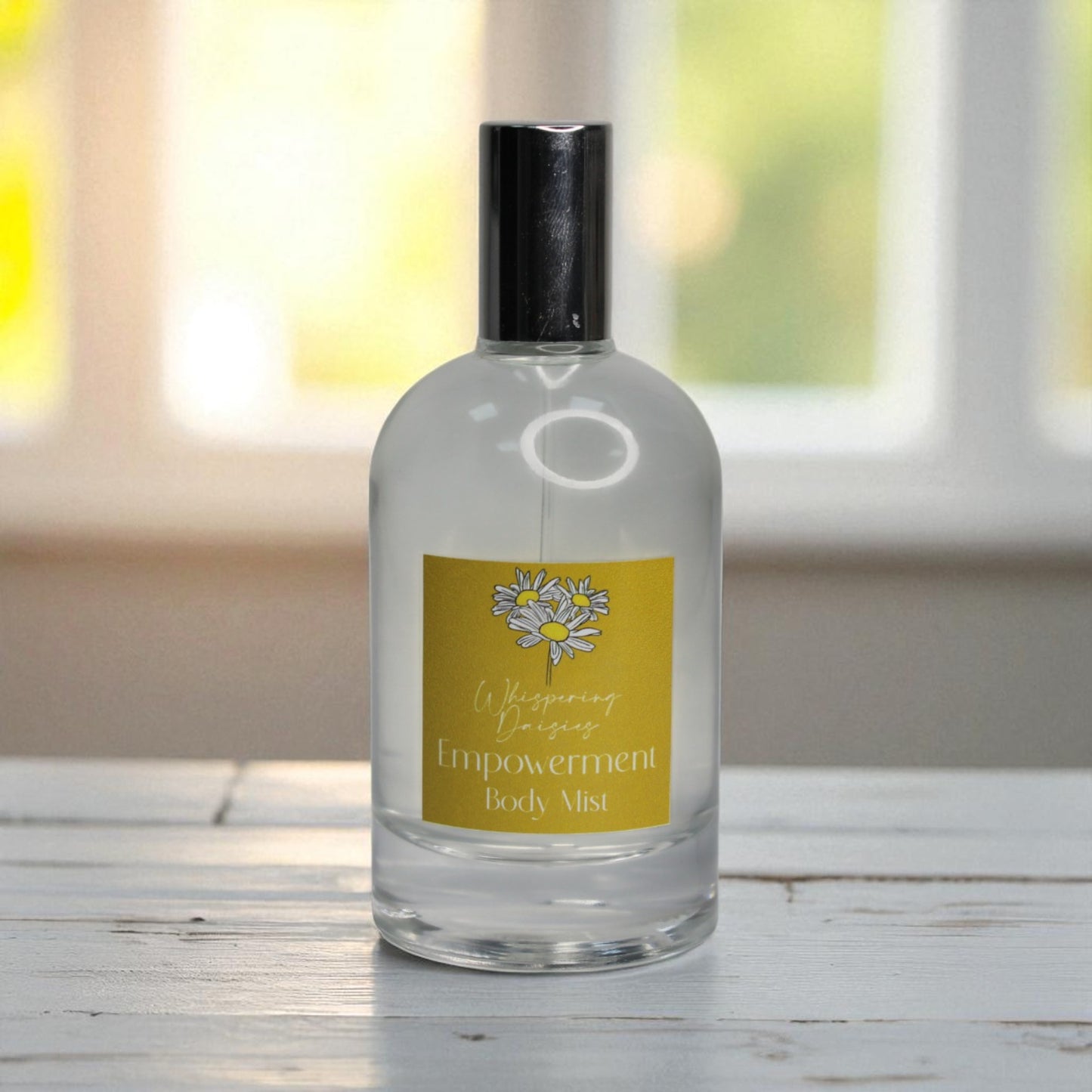 Body mist bottle with a yellow label on a wooden surface