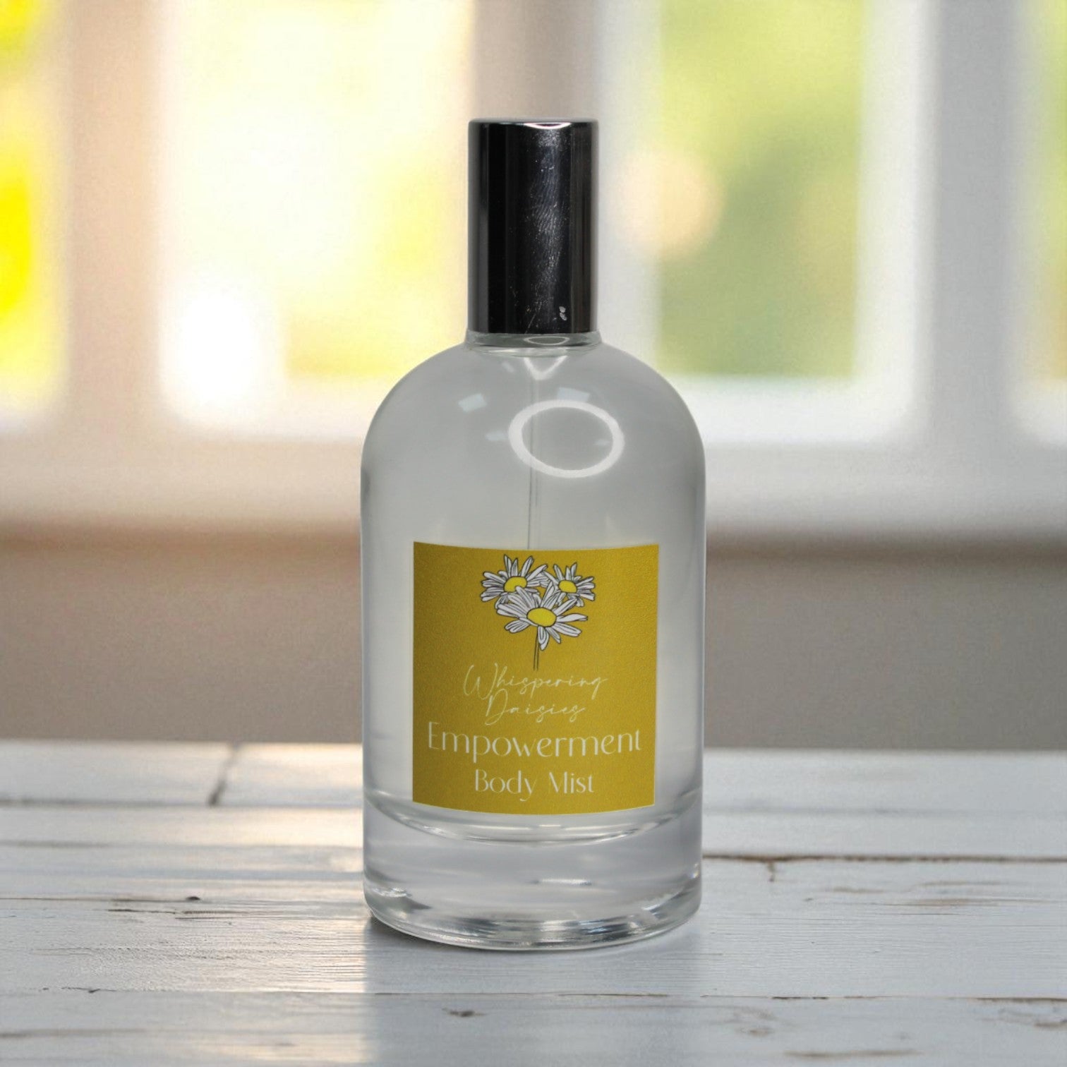 Body mist bottle with a yellow label on a wooden surface