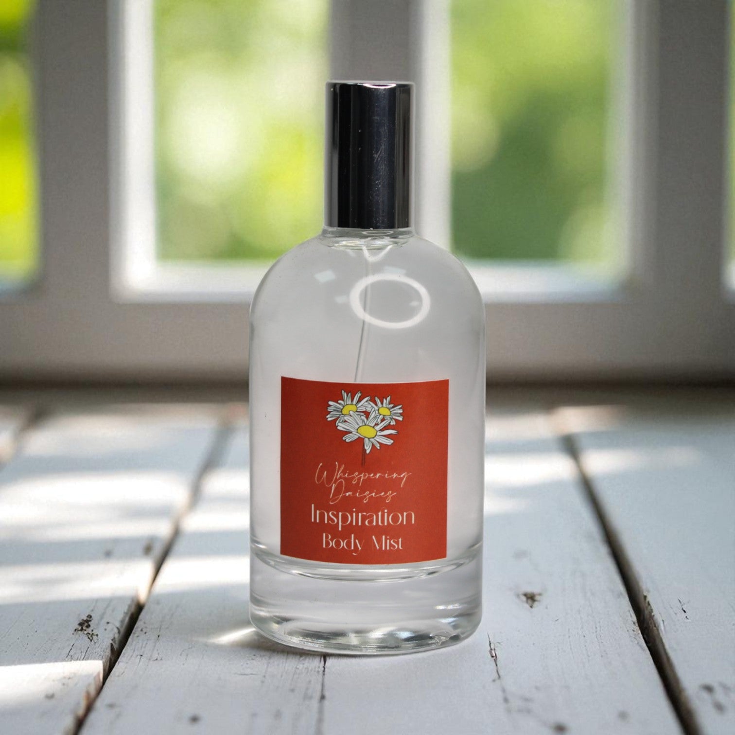 Clear bottle with a orange label on a wooden surface with a blurred green background